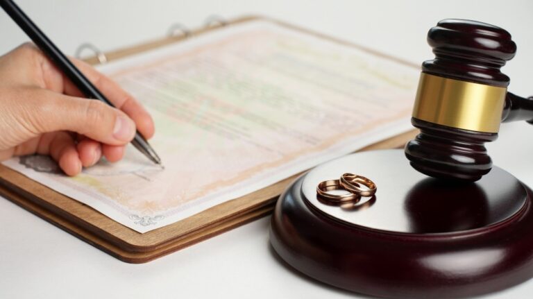 Divorce papers with gavel and rings