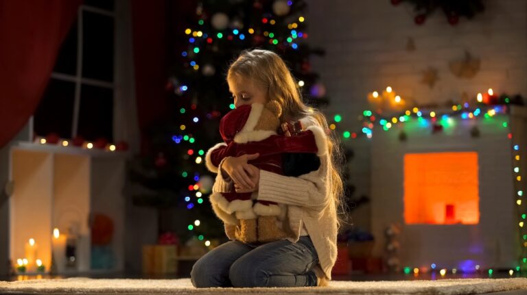 Upset girl hugging teddy bear on Christmas