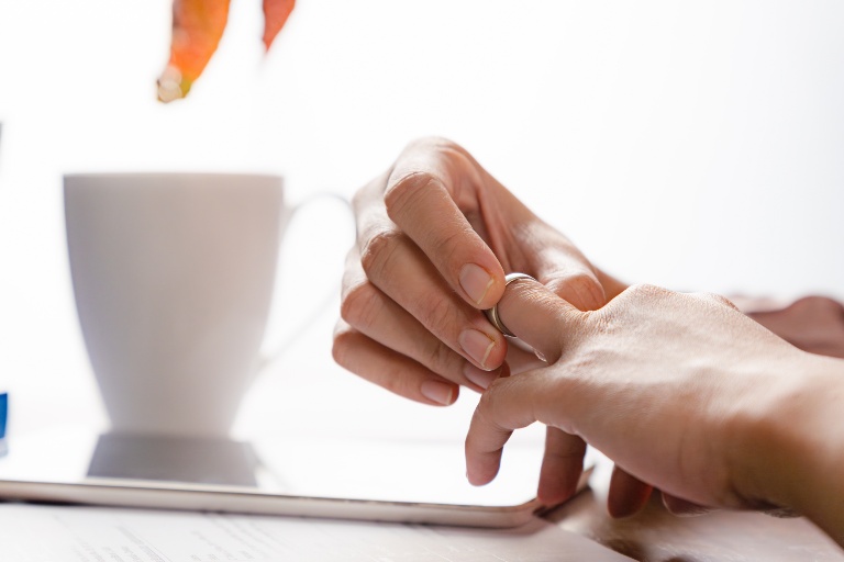 woman taking off her ring