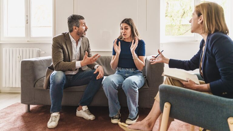 couple fighting on a couch with a mediator