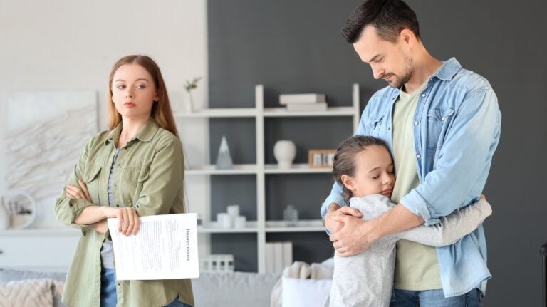 Little girl hugging her father after divorce at home