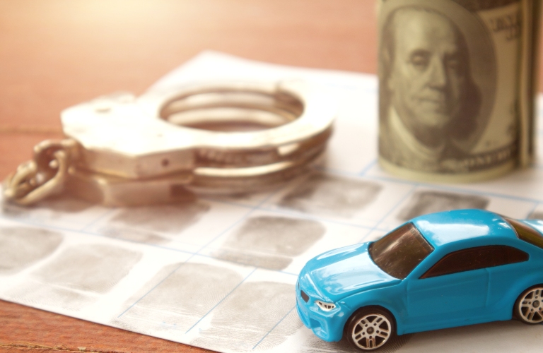 Car and police handcuff on fingerprint crime page file