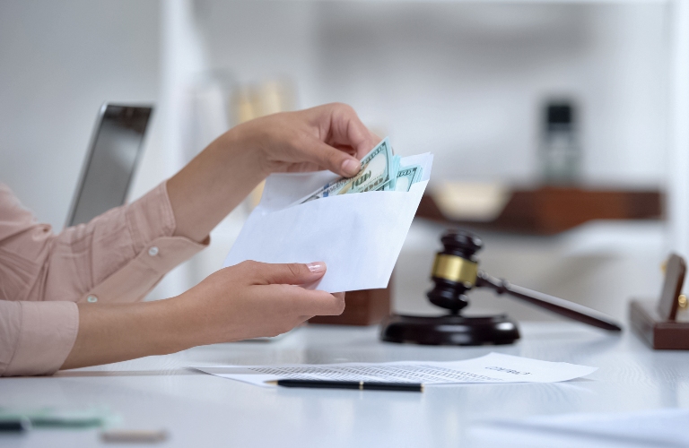Divorced woman holding envelope with dollars