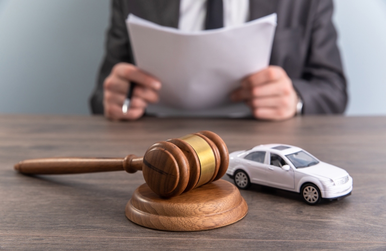 Model of car and gavel