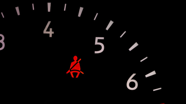 Seat belt warning light on vehicle dashboard
