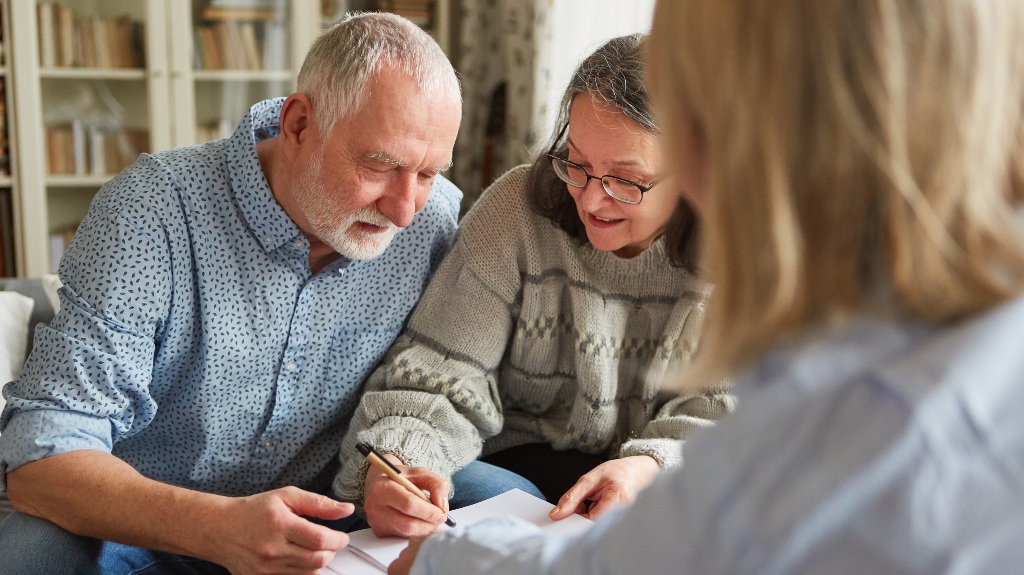 Senior couple signs a contract or power of attorney