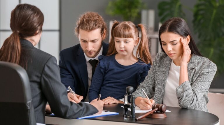 Young couple and their daughter visiting divorce lawyer in office