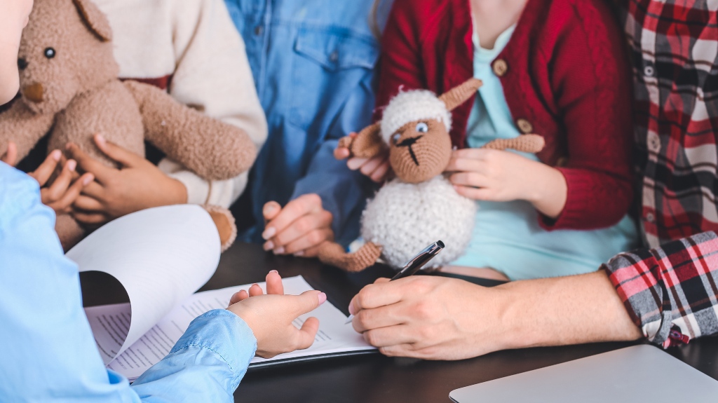lawyer meeting with divorced couple with children