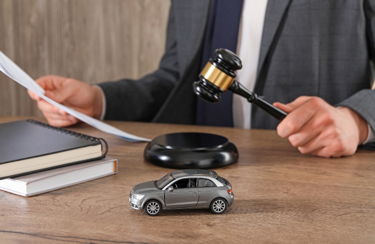 lawyer with document and gavel and car model