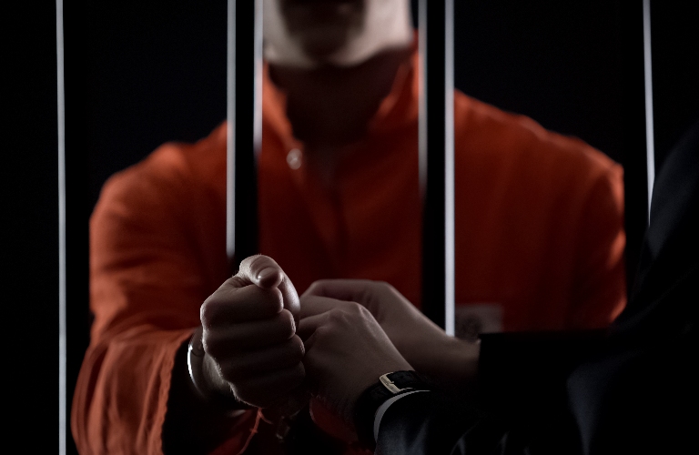 Guard taking handcuffs off