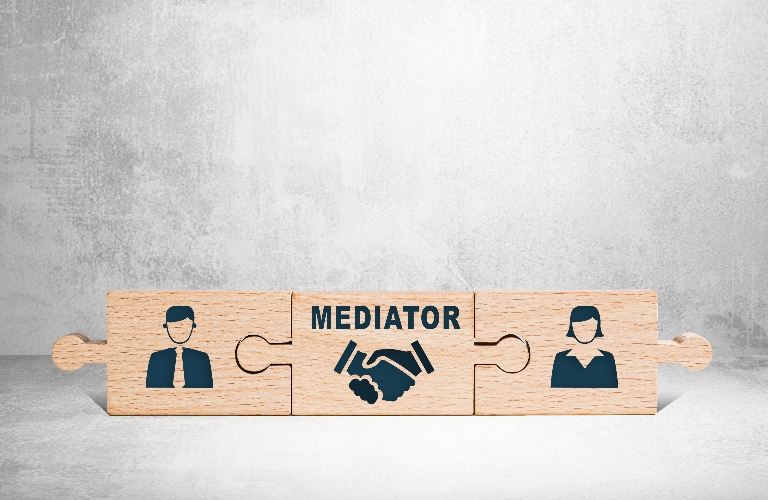 Wooden puzzle with icons of a man, mediator and woman