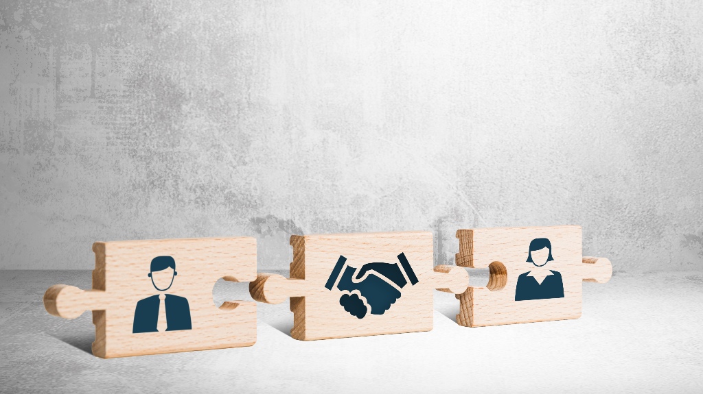 Wooden puzzle with icons of a man, mediator and woman