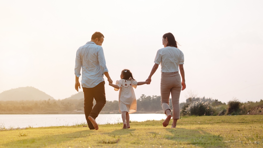 Happy family in the park sunset light