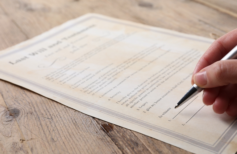 Woman signing Last Will and Testament