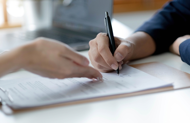 Woman is signing document