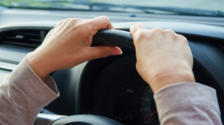 Woman's hands on the steering wheel