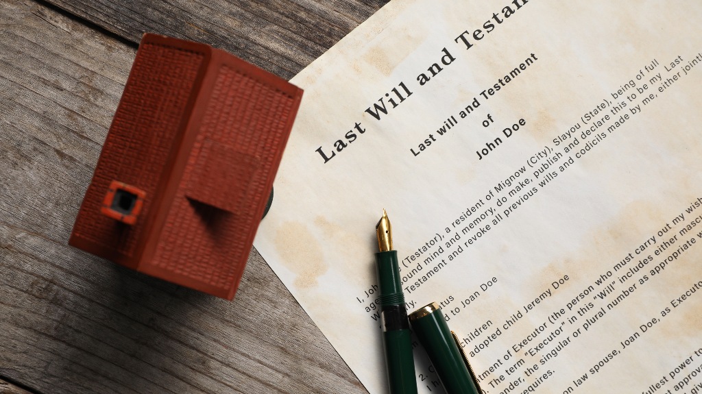 Last Will and Testament with fountain pen and house model
