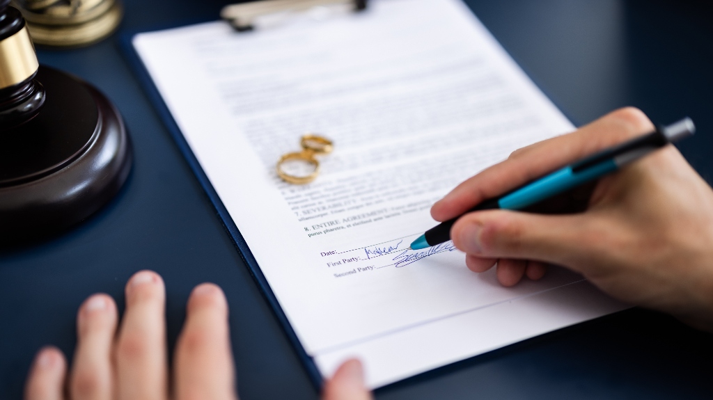 Man is signig a divorce agreement document