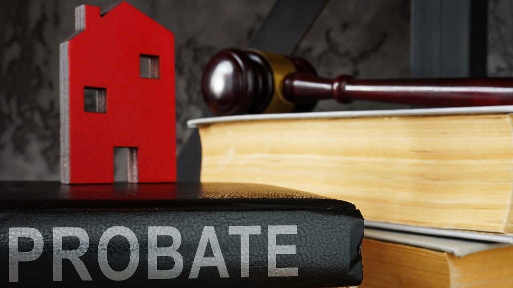Probate law book and model of house on it