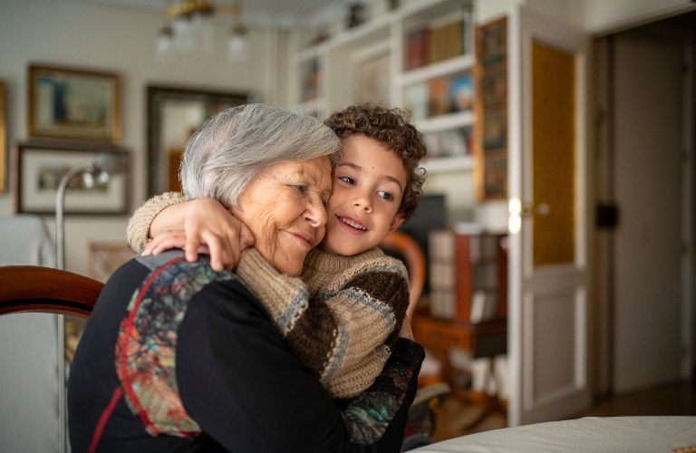Grandson is hugging his grandmother