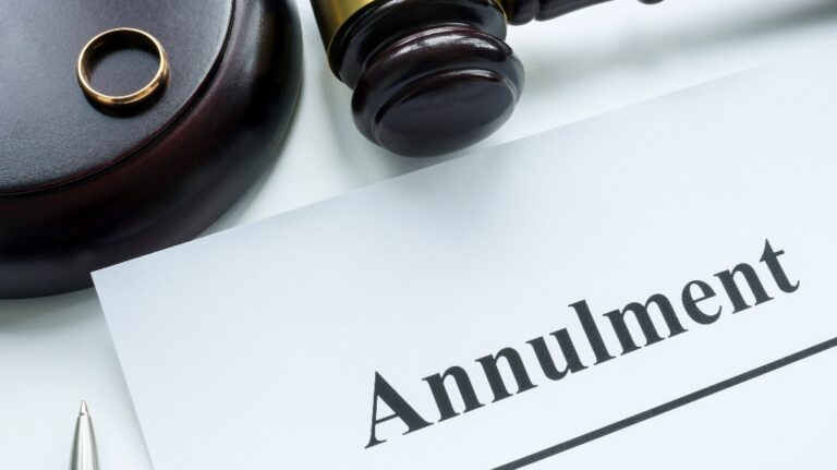 Papers about annulment, wedding ring and a judge's gavel