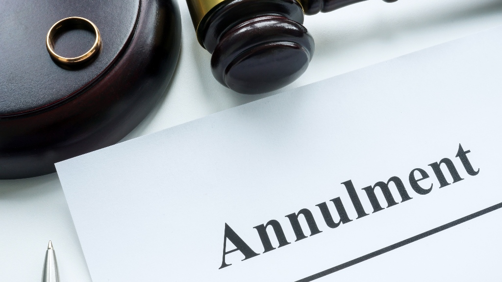Papers about annulment, wedding ring and a judge's gavel