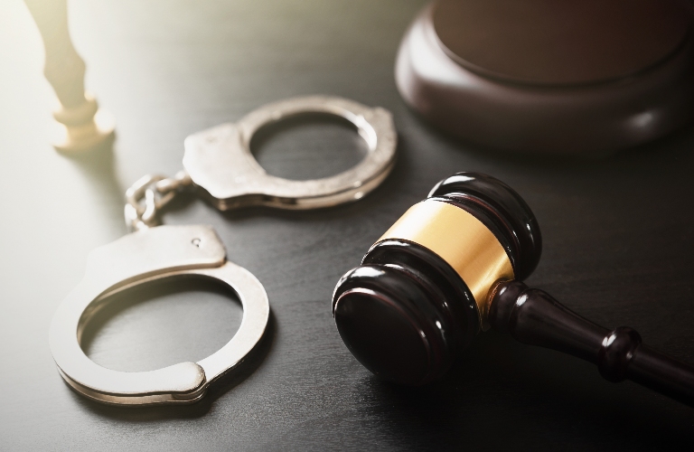 Handcuffs and judge's gavel