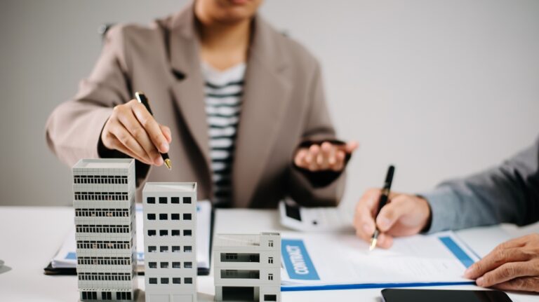 Real estate agent and investor discussing commercial property contract